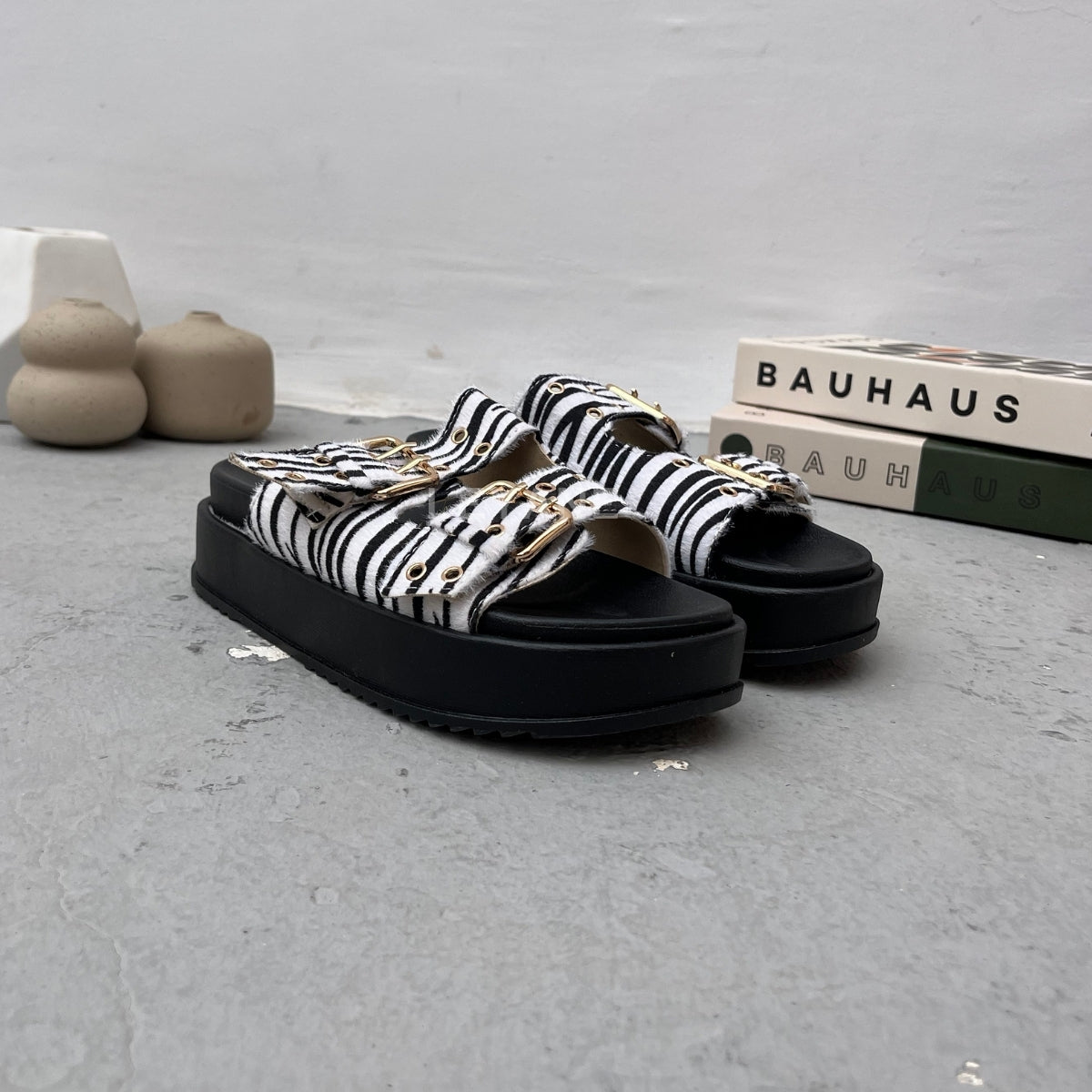 Sandales plates à bouts rond avec brides larges, boucles réglables et clous. Souples&nbsp;et légères, parfaites pour une journée de confort et de style.